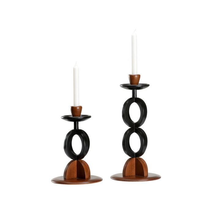 Two candle holders with black circular designs on a white background
