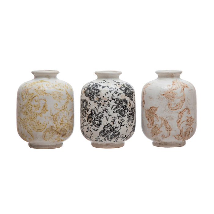 Set of three terracotta vases with different patterns, including floral and geometric designs.