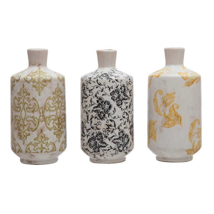 A set of three terracotta vases with different floral patterns in beige, white, and yellow colors.