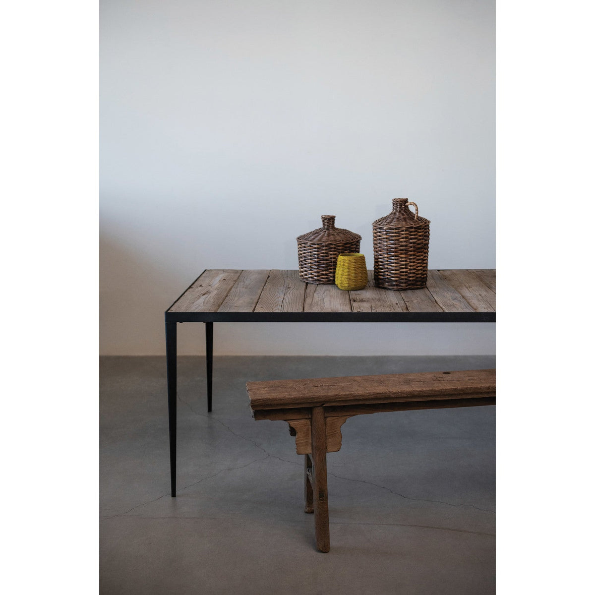 Wooden table with decorative items against a plain wall