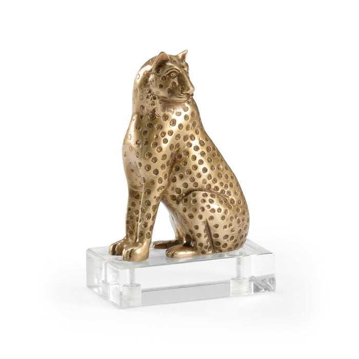 Bronze cheetah figurine on a clear base against a white background