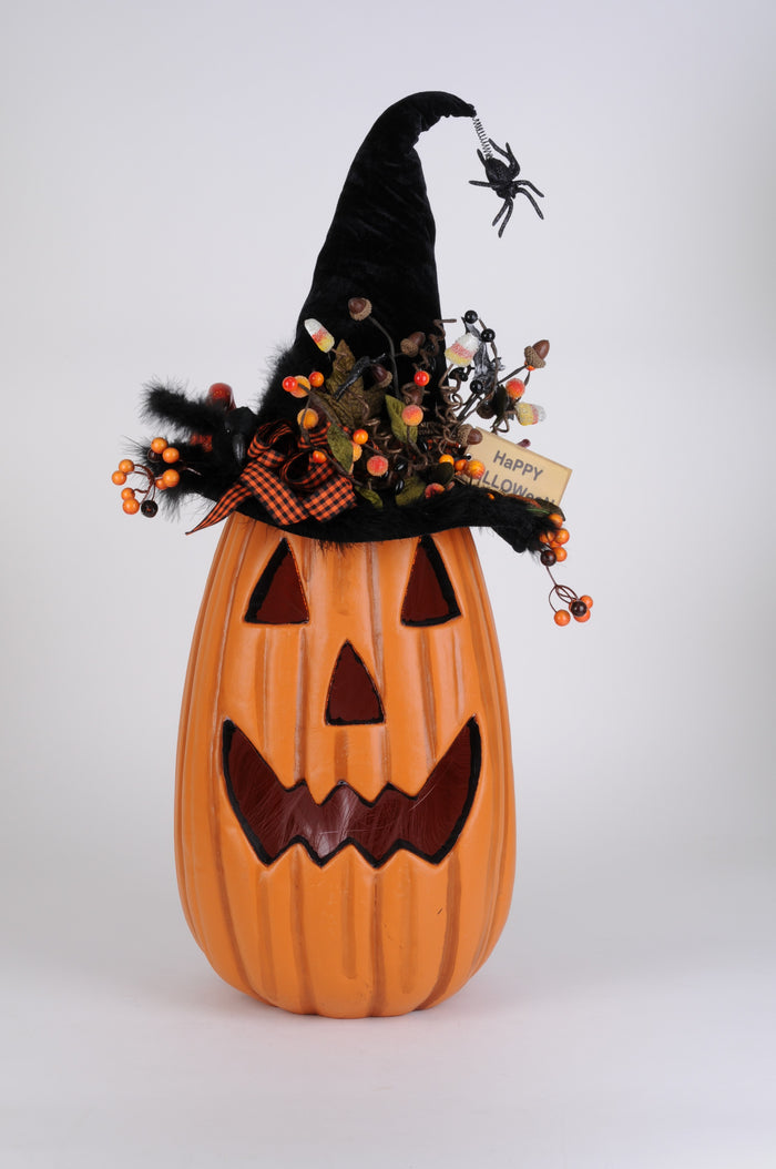 Decorative Halloween pumpkin with witch hat and spider on a white background