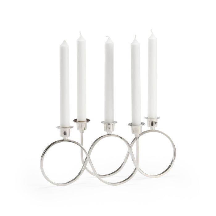 Silver candelabra with five white candles on a white background