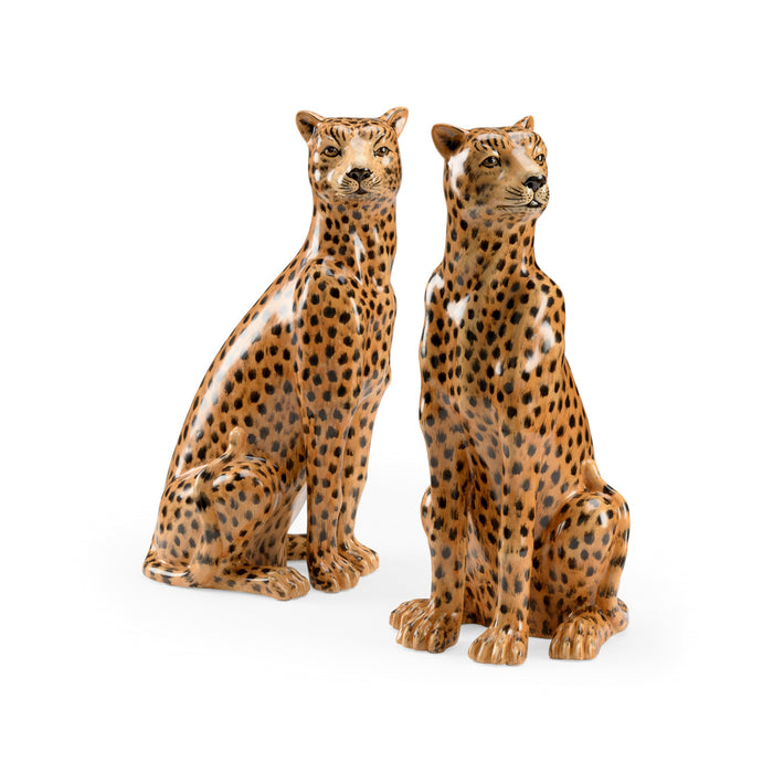 Two ceramic cheetah figurines on a white background