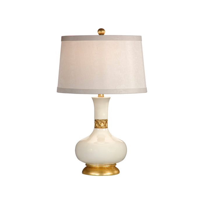 Table lamp with white shade and gold accents on a white background