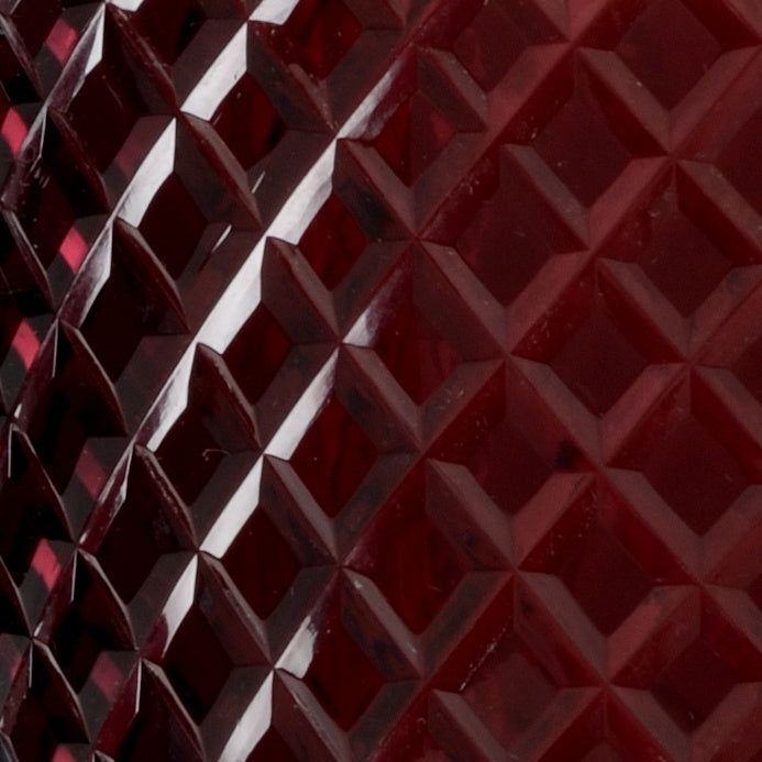 Close-up of a red textured surface with diamond pattern