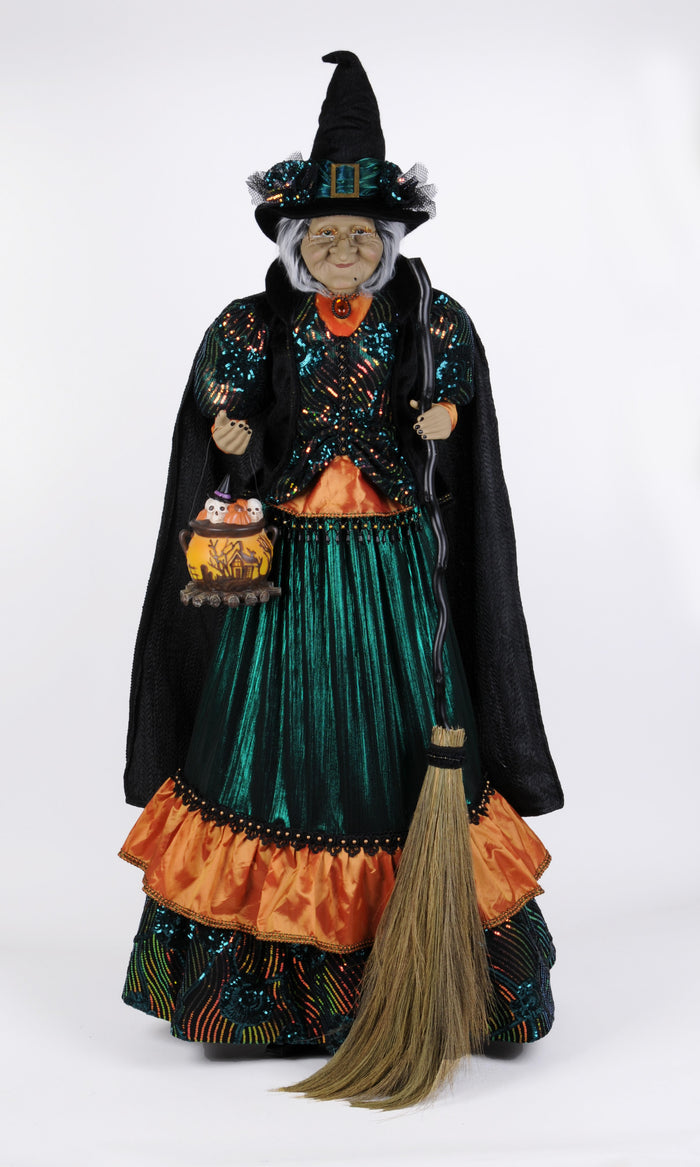 Decorative witch figurine with a broom on a white background