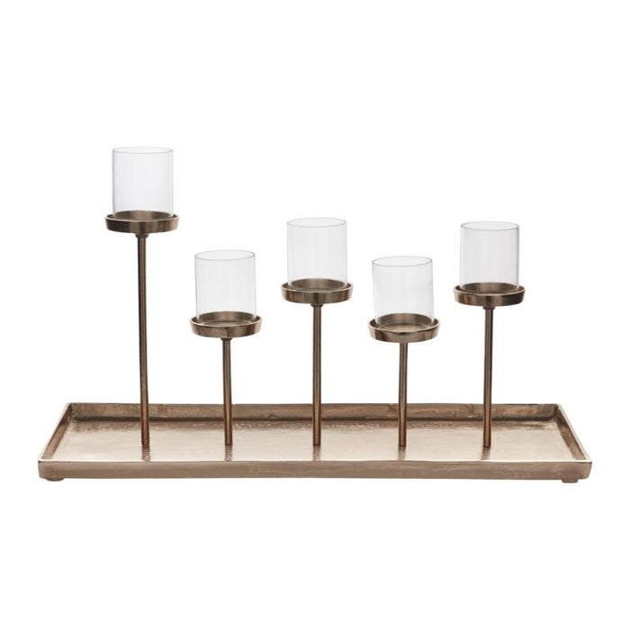 Brass candle holder tray with five glass hurricane cups on varying heights, modern rustic finish.
