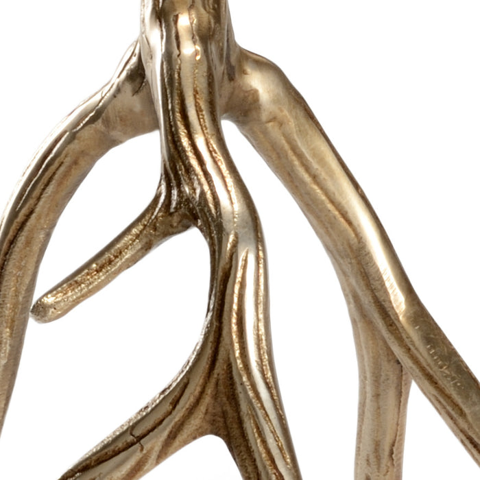 Close-up of a gold antler-like decorative item on a white background