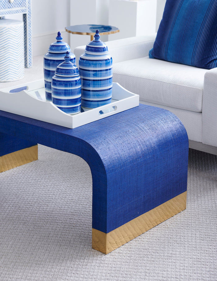 Blue coffee table with decorative items in a living room setting