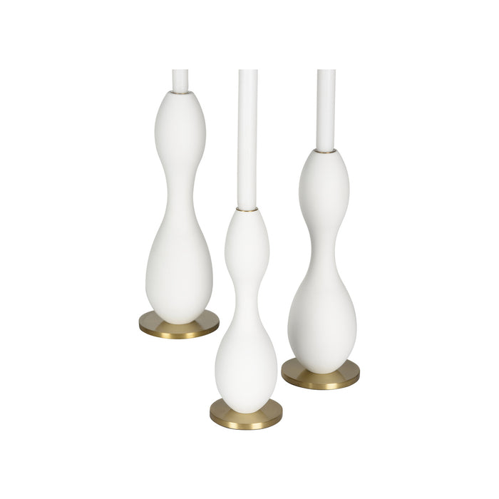 Set of three white candle holders with gold bases on a white background
