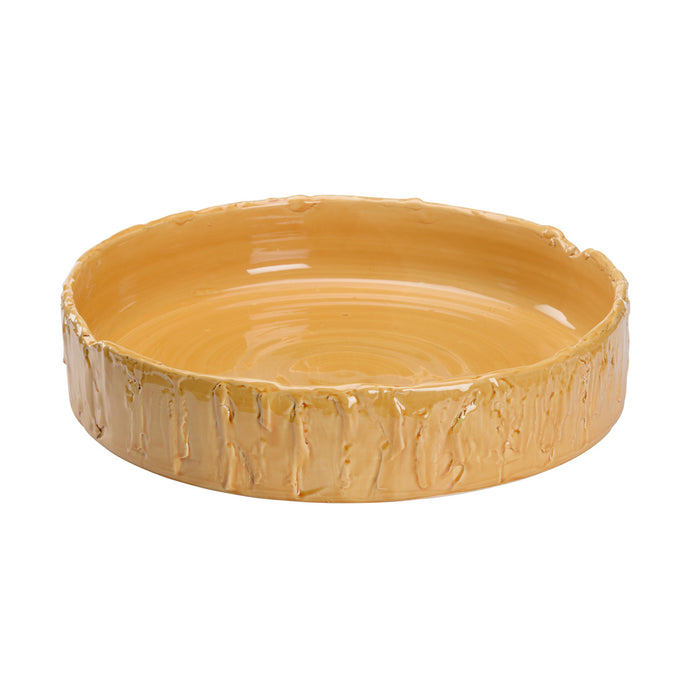 Yellow ceramic dish with textured rim on a white background