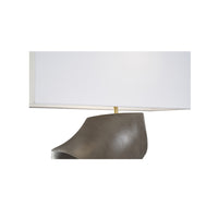 Table lamp with a white shade and bronze base on a white background