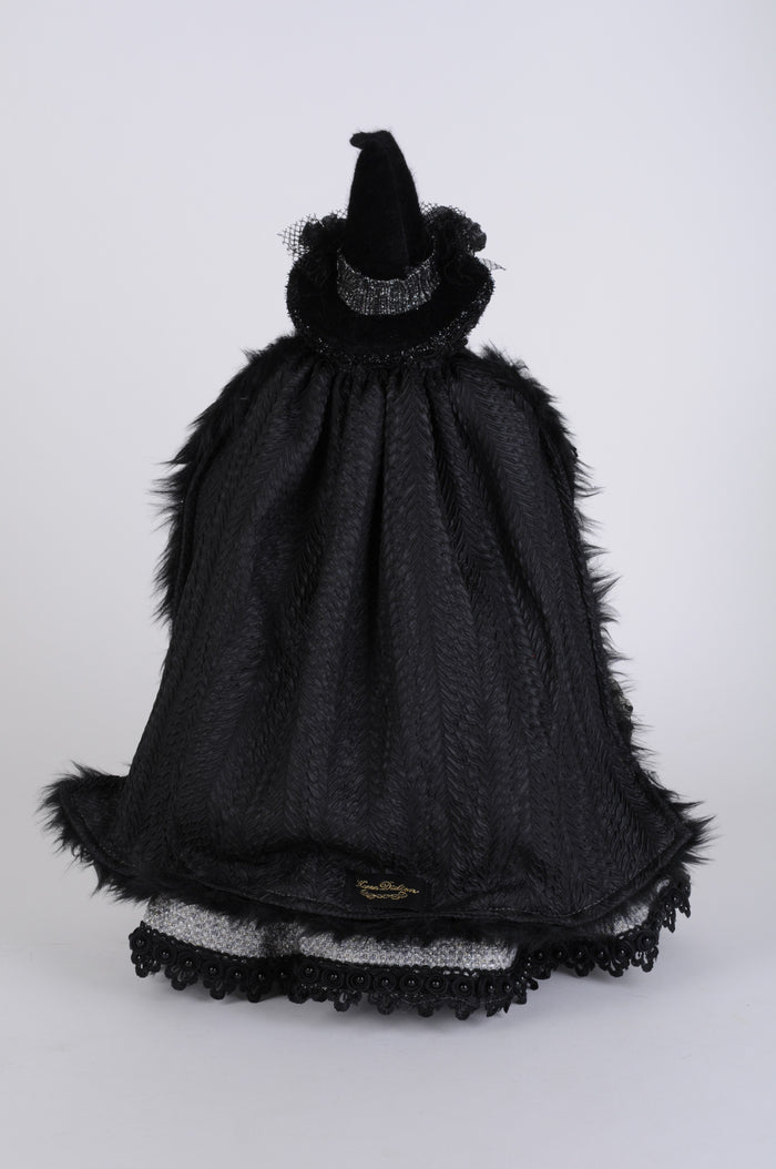 Black witch costume with hat and cape on a white background