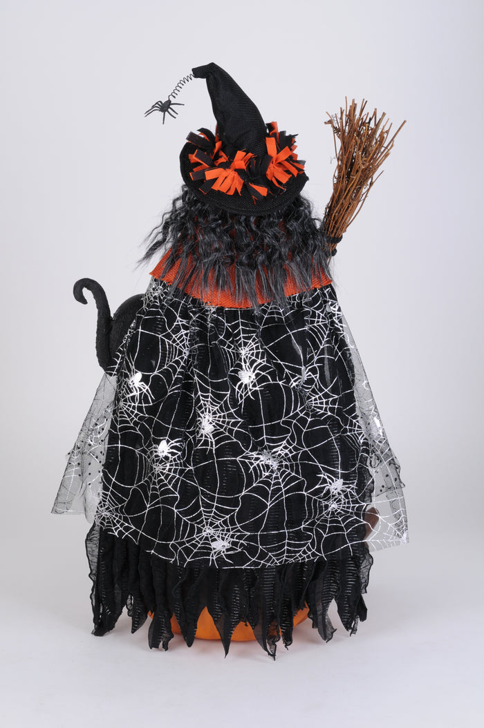 Halloween-themed decoration with a witch outfit, broom, and spider web pattern on a white background