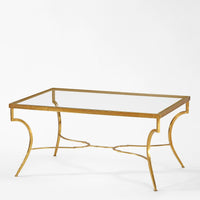 Gold-framed glass-top coffee table on a white background