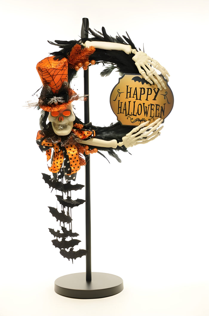 Halloween-themed decorative wreath with skeleton hand, skull, and 'Happy Halloween' sign on a stand.