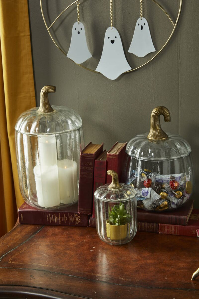 Decorative glass jars on a wooden surface with a blurred background