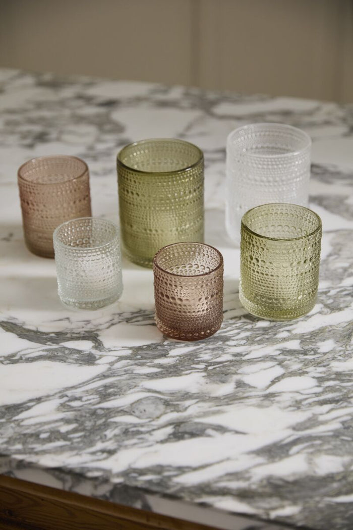 Set of textured glass tumblers on a marble surface