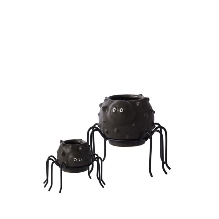 Two black spider-shaped planters on a white background