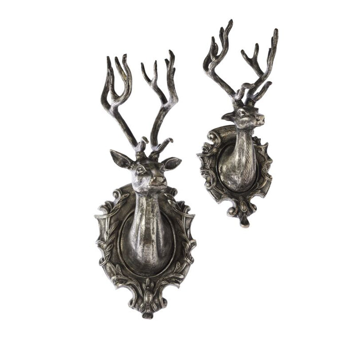 Pair of silver deer head wall mounts on a white background