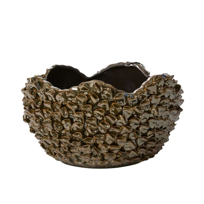 Decorative metallic bowl with textured surface on a white background