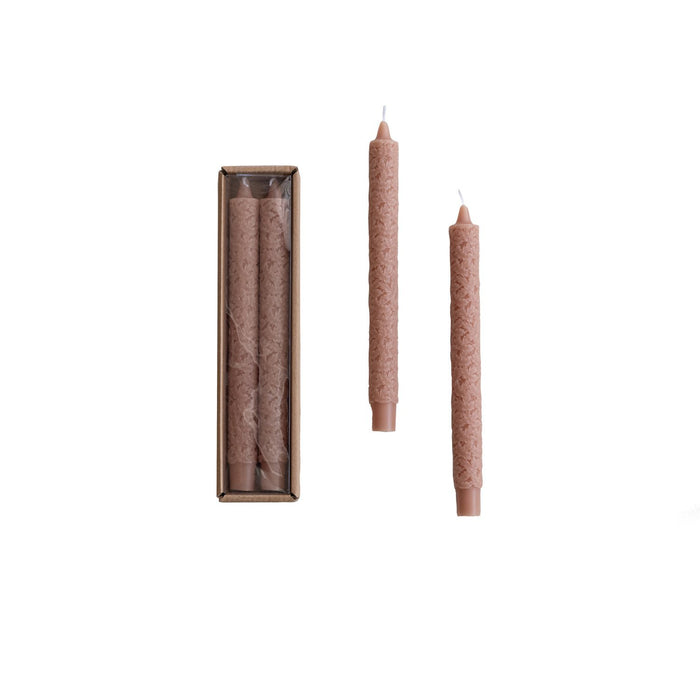 A set of two unscented taper candles with a maple leaf pattern, displayed alongside their packaging box.