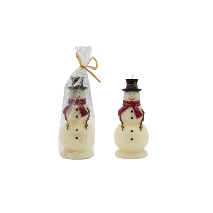 Two snowman-shaped candles, one packaged in a clear bag with a yellow ribbon, and the other displayed outside with a red scarf and green hat.