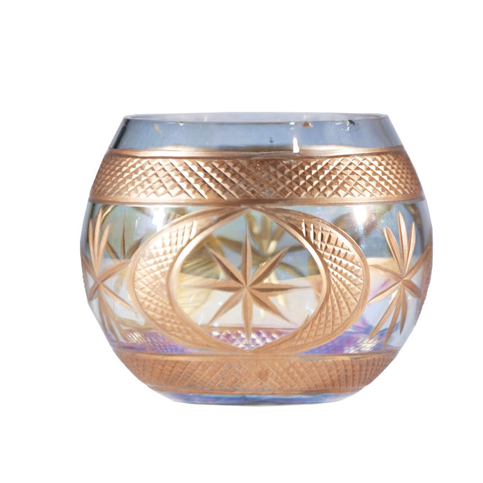 Decorative glass candle holder with gold patterns on a white background