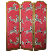 Three-panel folding screen with gold frame and red panels featuring black-and-white zebra prints.
