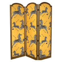 Three-panel folding screen with yellow background and black-and-white zebra prints, wooden frame, hinges visible.